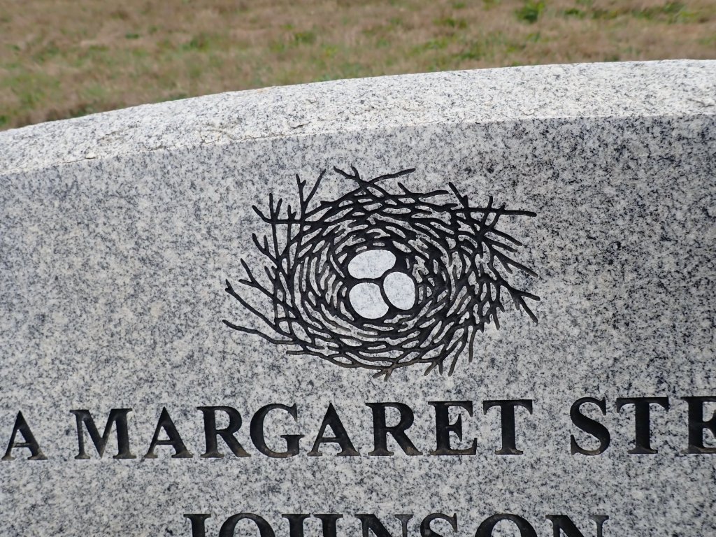 Photo of a bird nest carved into a tombstone